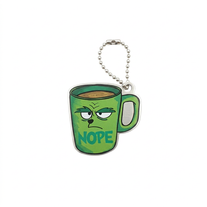 Nope Travel Tag featuring a grumpy green mug with NOPE lettering and compact silver chain on white