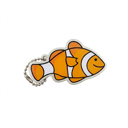 Anemone the Clown Fish orange-and-white travel tag with compact silver chain on white