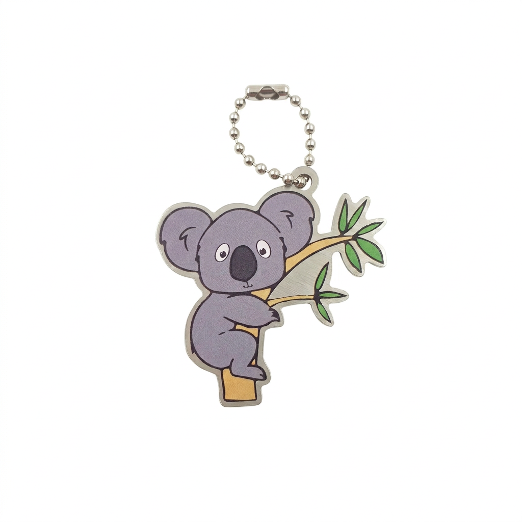 Sydney the Koala travel tag hugging a eucalyptus branch with compact silver chain on white