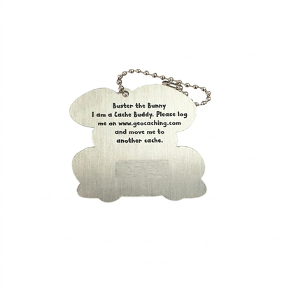 Reverse of Buster the Bunny aluminium trackable tag with logging instructions and unique tracking code hidden