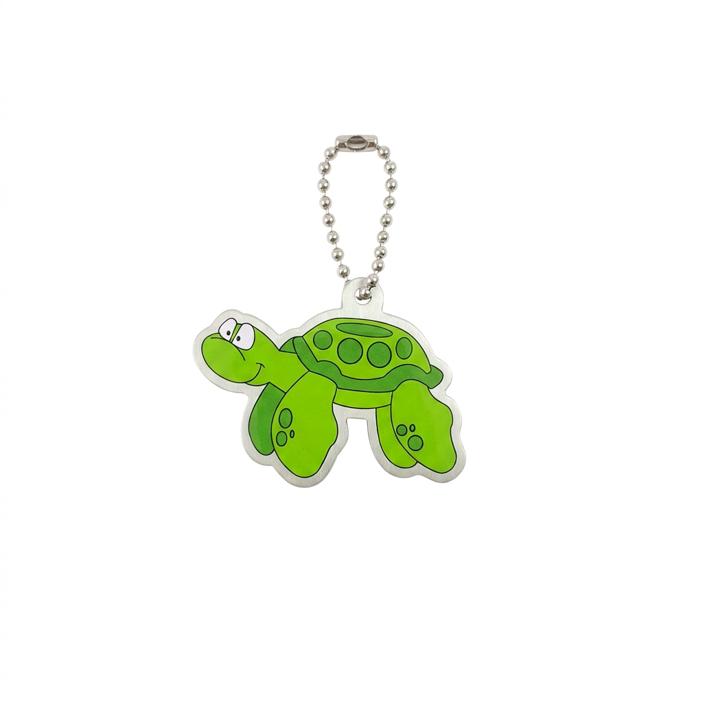 Tyler the Turtle green travel tag with patterned shell, flippers and compact silver chain on white