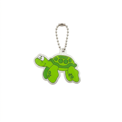 Tyler the Turtle green travel tag with patterned shell, flippers and compact silver chain on white