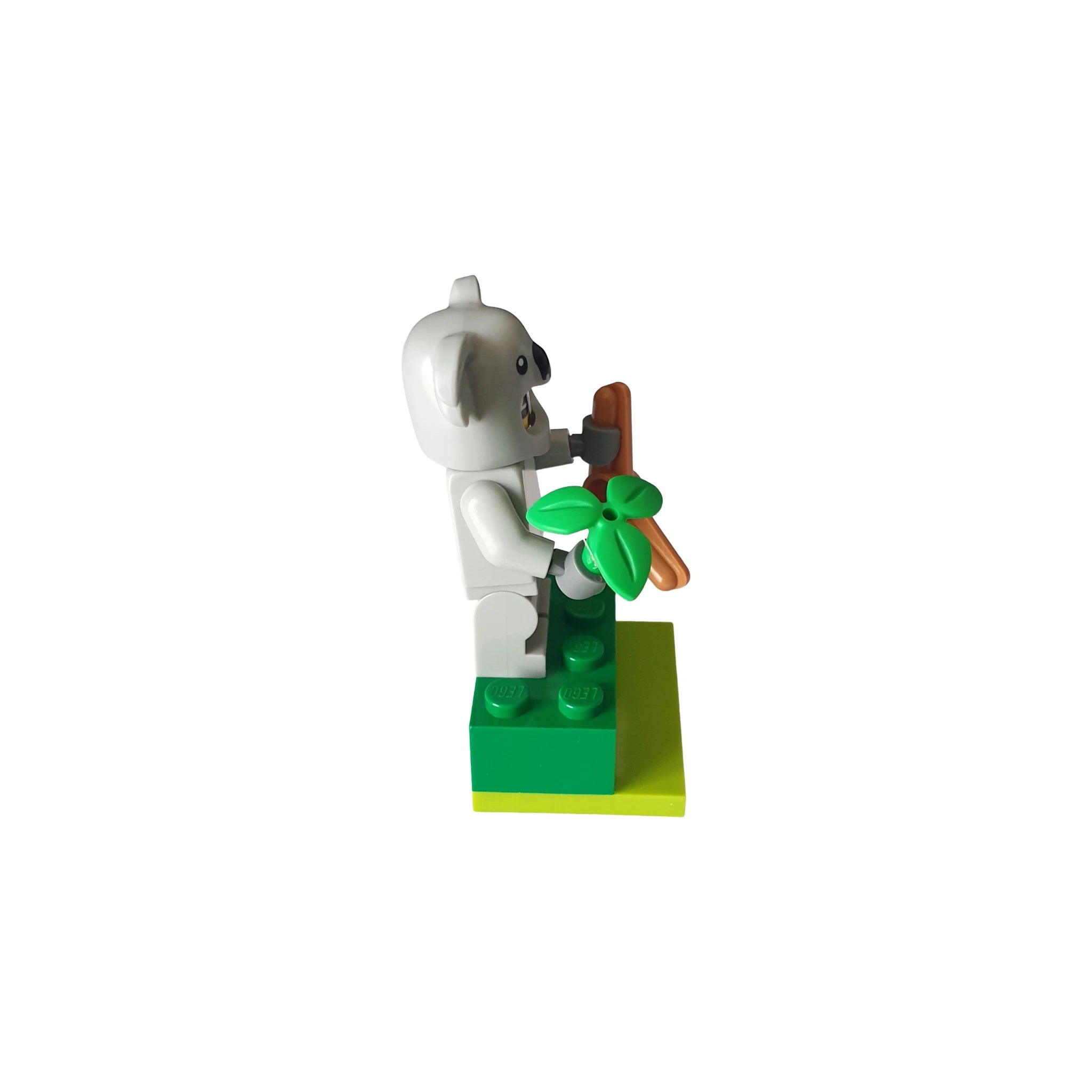 LEGO koala minifigure holding branch and leaves, displayed on green base, geocaching accessory