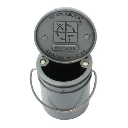 Open 3D bucket geocoin showing magnets and Geocaching tracking design beneath the lid, with code obscured