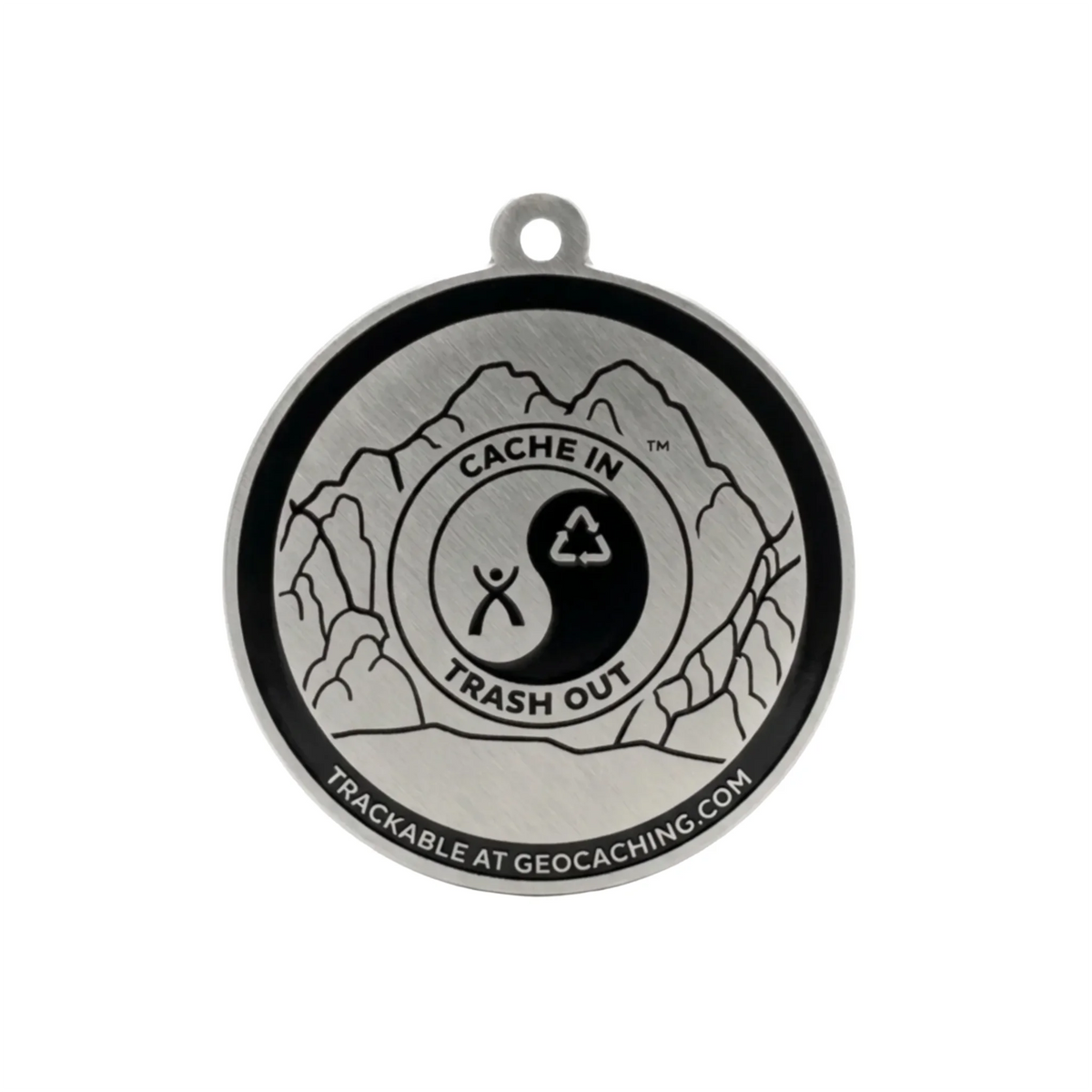 Reverse of CITO trackable tag with mountain engraving and tracking code hidden on a white background