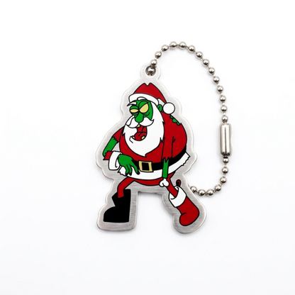 Zombie Claus Cache Buddy travel tag front with green Santa character and silver ball chain on white